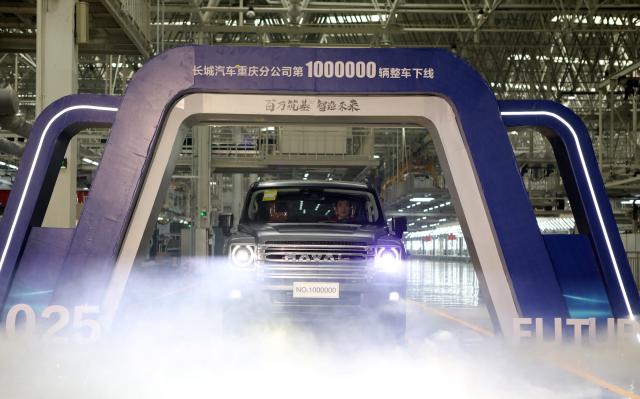 This photo taken on January 2, 2024 shows a brand-new H9 vehicle bearing a “1000000” label rolling off the production line at the Great Wall Motors' Chongqing smart factory in southwest China's Chongqing, marking the completion of the factory's one-millionth vehicle. (Photo by AFP) / China OUT