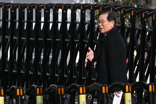 Yoon Kap-keun, lawyer for South Korea's impeached President Yoon Suk Yeol, arrives at Yoon Suk Yeol's residence in Seoul on January 3, 2025. South Korean investigators attempted to arrest impeached President at his residence on January 3 over a failed martial law bid, but security forces were blocking their efforts. South Korean President Yoon Suk Yeol's lawyer said Friday that investigators trying to detain the impeached leader were not acting lawfully, vowing to take further legal action against the move. (Photo by JUNG Yeon-je / AFP)