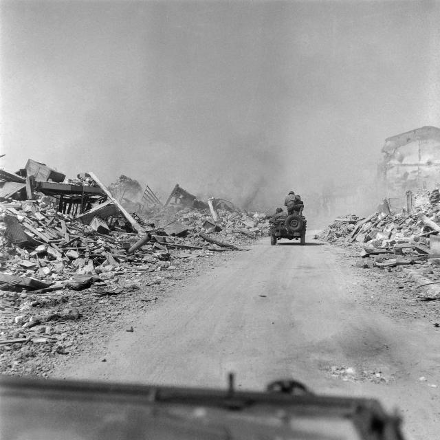 (FILES) A jeep of Allied troops patrol a destroyed street of Royan, on the French southwestern coast, in April 1945, after the Liberation of the city, during the Second World War. On January 5, 1945, Royan lay in ruins, the victim of a night-time deluge of Allied bombs that had killed 442 civilians: a series of misunderstandings and misfires had led to the destruction of the Charente coastal town, still held by the Germans. (Photo by AFP)