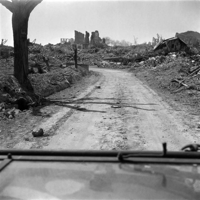 (FILES) Picture taken from a jeep of Allied troops runs in a destroyed street of Royan, on the French southwestern coast, in April 1945, after the Liberation of the city, during the Second World War. On January 5, 1945, Royan lay in ruins, the victim of a night-time deluge of Allied bombs that had killed 442 civilians: a series of misunderstandings and misfires had led to the destruction of the Charente coastal town, still held by the Germans. (Photo by AFP)