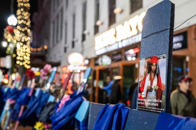 A cross with a pictures of 18-year-old victim Ni’Kyra Cheyenne Dedeaux is seen at a memorial on Bourbon Street after it reopened to the public on January 2, 2025, in New Orleans, Louisiana, following an attack on January 1 which left 14 dead. A US army veteran loyal to the Islamic State jihadist group likely acted alone when he killed 14 and injured dozens in a truck attack on a crowd of New Year revelers in New Orleans, the FBI said on January 2. (Photo by ANDREW CABALLERO-REYNOLDS / AFP)