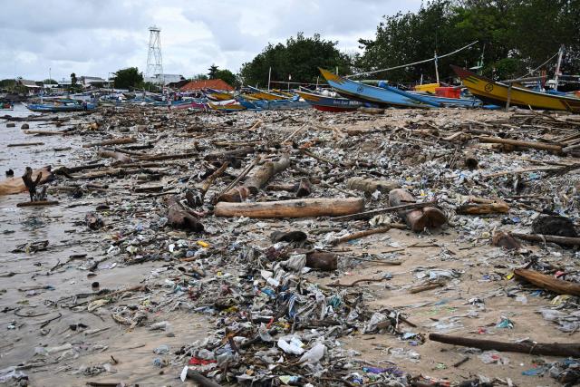 Plastic waste and garbage washed ashore has accumulated thickly at a beach in Kedonganan Badung regency, on the resort island of Bali on January 3, 2025. (Photo by SONNY TUMBELAKA / AFP)