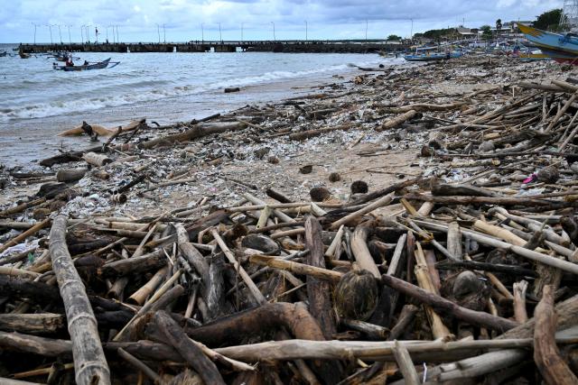 Plastic waste and garbage washed ashore has accumulated thickly at a beach in Kedonganan Badung regency, on the resort island of Bali on January 3, 2025. (Photo by SONNY TUMBELAKA / AFP)