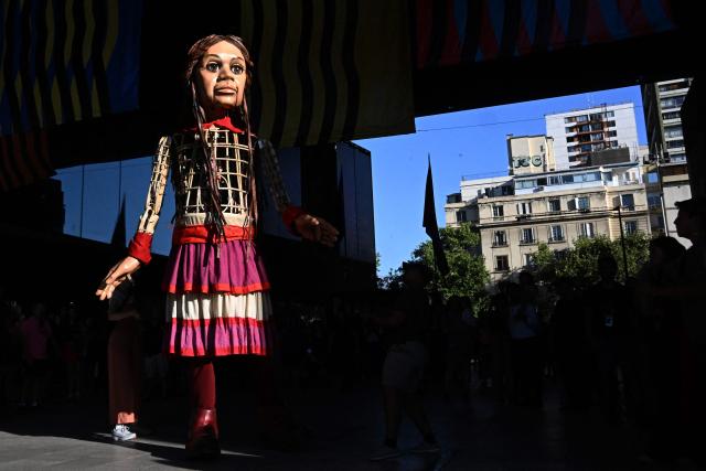 Little Amal, a 12-foot-tall puppet representing a ten-year-old Syrian refugee, is seen during a performance at the Gabriel Mistral Cultural Center as part of the opening of the 32nd version of the International Festival Teatro a Mil in Santiago on January 3, 2025. Santiago a Mil International Theatre Festival is an annual performing arts festival that takes place in January in Santiago, Chile. It is the largest arts festival in Chile and includes theatre, dance, and music events from Chile and abroad, performed in the capital city, Santiago, and around the country. (Photo by RODRIGO ARANGUA / AFP)