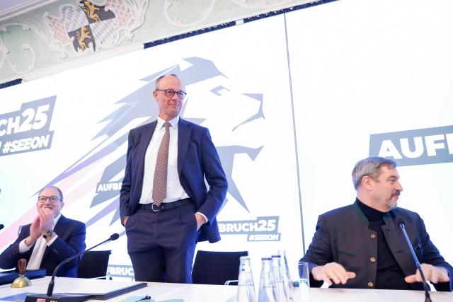 Leader of Germany's  Christian Democratic Union (CDU) Friedrich Merz (C) looks on flanked by parliamentary group leader of the Bavarian conservative Christian Social Union (CSU) party Alexander Dobrindt (L) and  Bavaria's State Premier and leader of the conservative Christian Social Union (CSU) party Markus Soeder during the CSU party's faction retreat in Seeon, southern Germany on January 8, 2025. (Photo by Michaela STACHE / AFP)