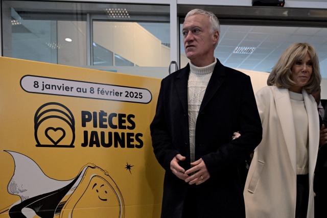 French national football team's head coach Didier Deschamps (L) and French President's wife Brigitte Macron stand outside Bordeaux's main post office in Bordeaux, southwestern France, on January 8, 2025, as they launch the 2025 edition of the charity fund called "Operations pieces jaunes" (operation yellow coins), with its foundation aiming to improve the conditions of hospitalized children. France's 2018 World Cup-winning head coach Didier Deschamps announced on January 8, 2025 he will leave his post after the 2026 finals. (Photo by Philippe Lopez / AFP)