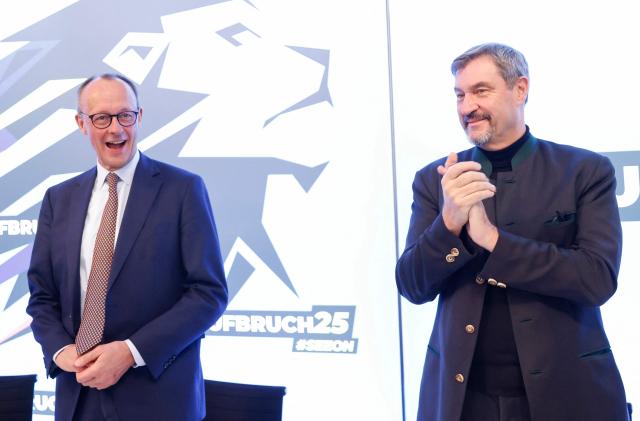 Leader of Germany's  Christian Democratic Union (CDU) Friedrich Merz (C) looks on next to Bavaria's State Premier and leader of the conservative Christian Social Union (CSU) party Markus Soeder during the CSU party's faction retreat in Seeon, southern Germany on January 8, 2025. (Photo by Michaela STACHE / AFP)