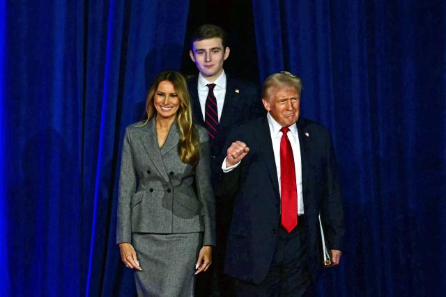 (FILES) Former US President and Republican presidential candidate Donald Trump (R) arrives for  an election night event alongside former US First Lady Melania Trump and his son Barron Trump at the West Palm Beach Convention Center in West Palm Beach, Florida, on November 6, 2024. Melania Trump signaled she intends to mostly live in the White House when she returns to Washington as first lady next Monday, squelching speculation that she might split time between other residences. (Photo by Jim WATSON / AFP)