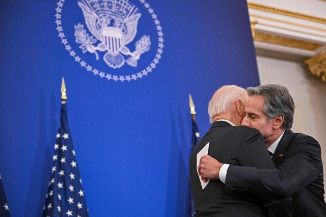 US President Joe Biden embraces US Secretary of State Antony Blinken at the State Department in Washington, DC, on January 13, 2025, before he delivered his final foreign policy speech. (Photo by ROBERTO SCHMIDT / AFP)