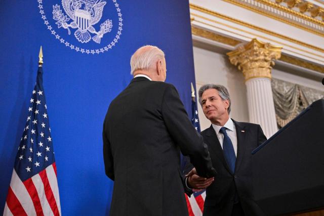 US President Joe Biden (L) shakes the hand of US Secretary of State Antony Blinken at the State Department in Washington, DC, on January 13, 2025, before he delivered his final foreign policy speech. (Photo by ROBERTO SCHMIDT / AFP)