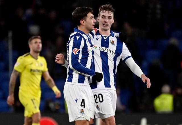 Real Sociedad's Spanish midfielder #04 Martin Zubimendi and Real Sociedad's Spanish defender #20 Jon Pacheco celebrate their victory at the end of the Spanish league football match between Real Sociedad and Villarreal CF at the Anoeta stadium in San Sebastian on January 13, 2025. (Photo by ANDER GILLENEA / AFP)