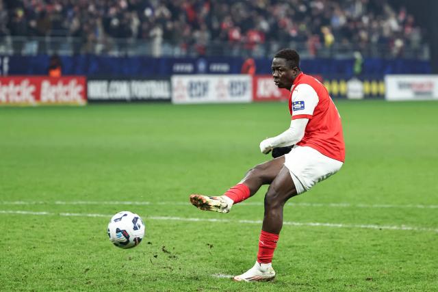 Reims' Ivorian midfielder #14 Oumar Diakite scores his team's victory goal at the end of the penalty shoot-outs of the French Cup (Coupe de France) last 32 football match between Reims and Monaco at the Stade Auguste-Delaune II in Reims, northern France, on January 14, 2025. (Photo by Sameer Al-DOUMY / AFP)