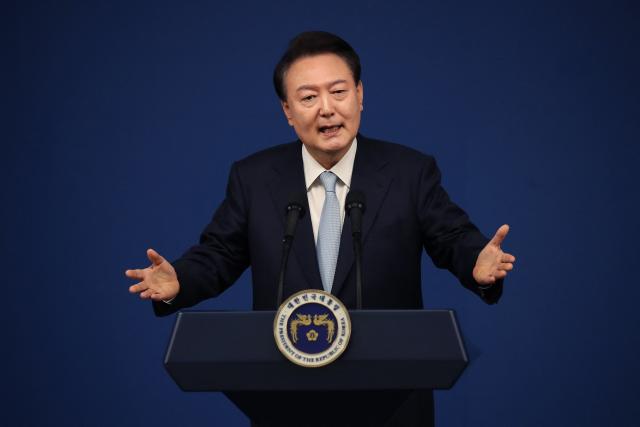 (FILES) South Korea's President Yoon Suk Yeol speaks during a press conference at the presidential office in Seoul on August 29, 2024. Impeached South Korean leader Yoon Suk Yeol was arrested on January 15, 2025 over his failed martial law bid, ending a weeks-long standoff with authorities and becoming the first president to be detained in the nation's history. (Photo by Chung Sung-Jun / POOL / AFP)