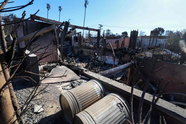 The entrance of Laeticia Hallyday's house is seen after being destroyed by the Palisades Fire, on January 14, 2025, in Pacific Palisades, California. Powerful winds forecast for late January 14 threatened to whip up massive fires that are still burning around Los Angeles in a tragedy that has killed at least 25 people and badly shaken the city. (Photo by VALERIE MACON / AFP)