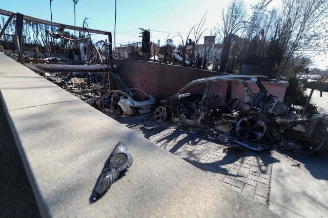 The entrance of Laeticia Hallyday's house is seen after being destroyed by the Palisades Fire, on January 14, 2025, in Pacific Palisades, California. Powerful winds forecast for late January 14 threatened to whip up massive fires that are still burning around Los Angeles in a tragedy that has killed at least 25 people and badly shaken the city. (Photo by VALERIE MACON / AFP)