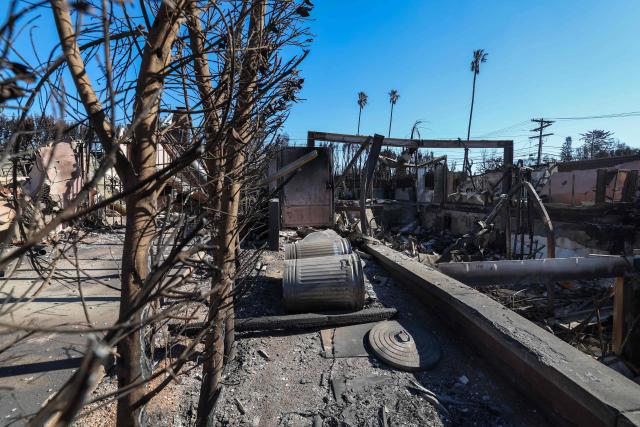 The entrance of Laeticia Hallyday's house is seen after being destroyed by the Palisades Fire, on January 14, 2025, in Pacific Palisades, California. Powerful winds forecast for late January 14 threatened to whip up massive fires that are still burning around Los Angeles in a tragedy that has killed at least 25 people and badly shaken the city. (Photo by VALERIE MACON / AFP)