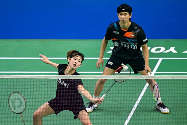 Japan's Maya Taguchi (L) and Yuta Watanabe play against Malaysia’s Wong Tien Ci and Lim Chiew Sien during their mixed doubles match at the Yonex-Sunrise India Open 2025 badminton tournament in New Delhi on January 15, 2025. (Photo by Money SHARMA / AFP)