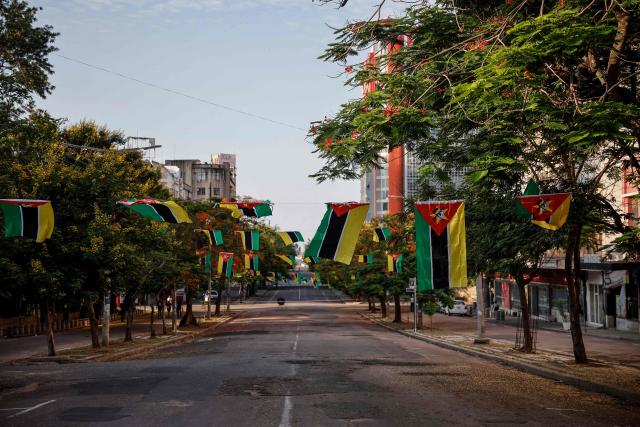 A general view of Mozambique national flags hung in a street leading to Independence Square where Mozambique President-elect Daniel Chapo will be sworn into office in Maputo on January 15, 2025. (Photo by PHILL MAGAKOE / AFP)