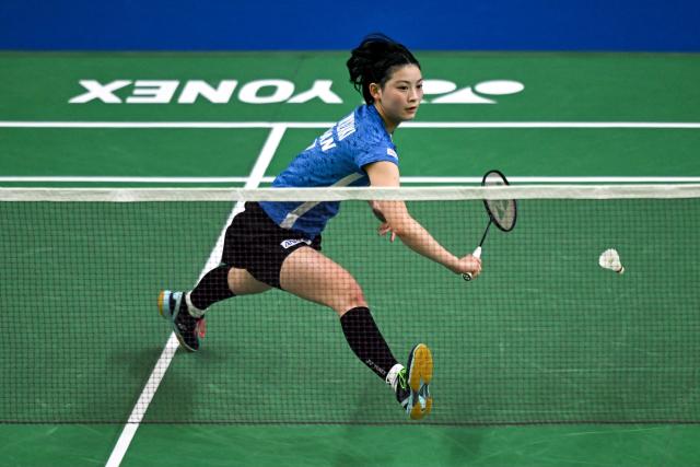 Japan's Tomoka Miyazaki plays against Thailand’s Pornpicha Choeikeewong during their women’s singles match at the Yonex-Sunrise India Open 2025 badminton tournament in New Delhi on January 15, 2025. (Photo by Money SHARMA / AFP)