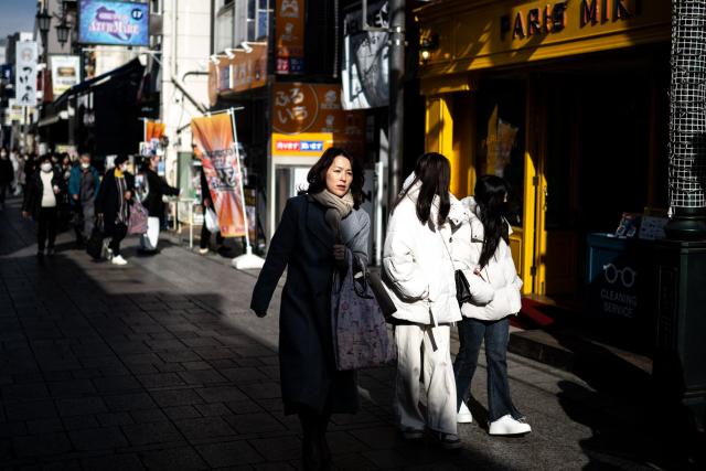 Pedestrians walk along a shopping street in Kawagoe city, known locally as "The Little Edo" and famous for its historic buildings, in Saitama Prefecture on January 15, 2025. Japan is expected to announce tourist figures for the year 2024 later in the day on January 15, widely expected to break the record set in 2019. (Photo by Philip FONG / AFP)