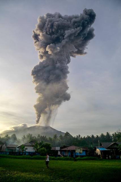 Volcanic ash rises during the eruption of Mount Ibu, as seen from Duono Village in West Halmahera, North Maluku province, on January 15, 2025. (Photo by AZZAM / AFP)