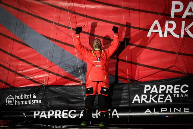 French skipper Yoann Richomme, on his Imoca 60 monohull Paprec Arkea, celebrates as he crosses the line to finish in second place in the 10th edition of the Vendee Globe around the world monohull solo sailing race in Les Sables-d'Olonne, western France, on January 15, 2025. (Photo by Loic VENANCE / AFP)