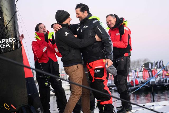 French skipper Charlie Dalin (L) and winner of the 10th edition of the Vendee Globe greets French skipper Yoann Richomme, on his Imoca 60 monohull Paprec Arkea, who arrives at the port, finishing in second place in the 10th edition of the Vendee Globe around the world monohull solo sailing race in Les Sables-d'Olonne, western France, on January 15, 2025. (Photo by Loic VENANCE / AFP)