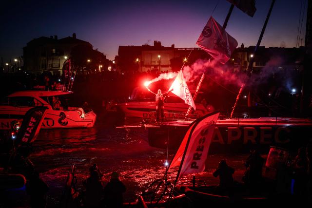 TOPSHOT - French skipper Yoann Richomme, on his Imoca 60 monohull Paprec Arkea, enters the channel to finish in second place in the 10th edition of the Vendee Globe around the world monohull solo sailing race in Les Sables-d'Olonne, western France, on January 15, 2025. (Photo by Loic VENANCE / AFP)