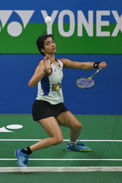 India’s Malvika Bansod plays against China’s Han Yue during their women’s singles match at the Yonex-Sunrise India Open 2025 badminton tournament in New Delhi on January 15, 2025. (Photo by Money SHARMA / AFP)