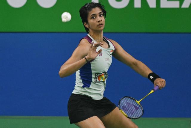 India’s Malvika Bansod plays against China’s Han Yue during their women’s singles match at the Yonex-Sunrise India Open 2025 badminton tournament in New Delhi on January 15, 2025. (Photo by Money SHARMA / AFP)