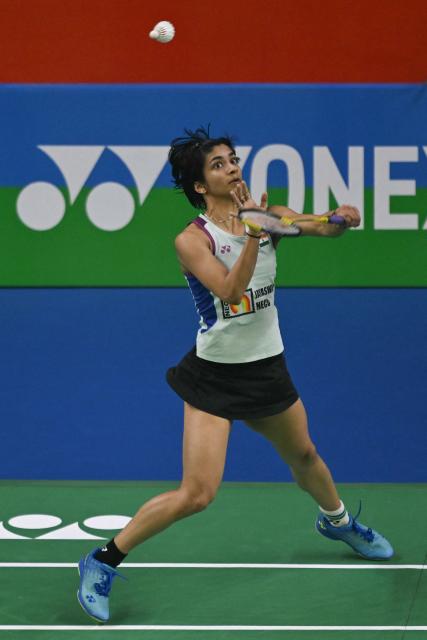 India’s Malvika Bansod plays against China’s Han Yue during their women’s singles match at the Yonex-Sunrise India Open 2025 badminton tournament in New Delhi on January 15, 2025. (Photo by Money SHARMA / AFP)