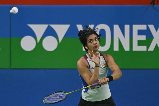 India’s Malvika Bansod plays against China’s Han Yue during their women’s singles match at the Yonex-Sunrise India Open 2025 badminton tournament in New Delhi on January 15, 2025. (Photo by Money SHARMA / AFP)