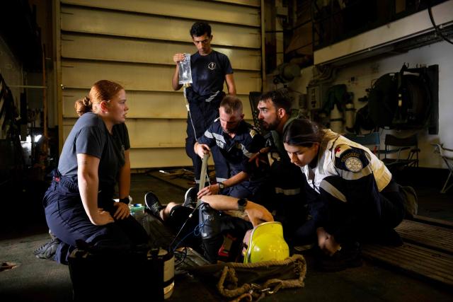 Members of the French Navy's medical team treat a patient brought aboard the French surveillance frigate FS Ventose during a medical evacuation mission by Eurocopter AS565 Panther military helicopter on the ship as it sails on a mission off the French Caribbean island of Martinique, on November 14, 2024. The French surveillance frigate FS Ventose is deployed at sea on a Narcops mission to intercept narco-traffickers' vessels potentially transporting narcotics, as part of the fight against drug trafficking in the French West Indies. (Photo by JULIEN DE ROSA / AFP)