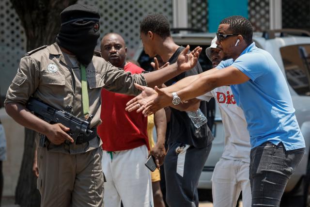 A Mozambique police officer (L) gestures towards a protester in Maputo on January 15, 2025, following the inauguration of Daniel Chapo as the President of Mozambique. Mozambique swore in Daniel Chapo as president on January 15, 2025 following months of post-election violence that an NGO says has killed more than 300 people.
Vowing "to devote all my energies to defending, promoting and consolidating national unity", Chapo, 48, extends his Frelimo party's 50-year rule of the gas-rich African nation. Opposition candidate Venancio Mondlane claims that the October 2024 election was rigged. (Photo by PHILL MAGAKOE / AFP)