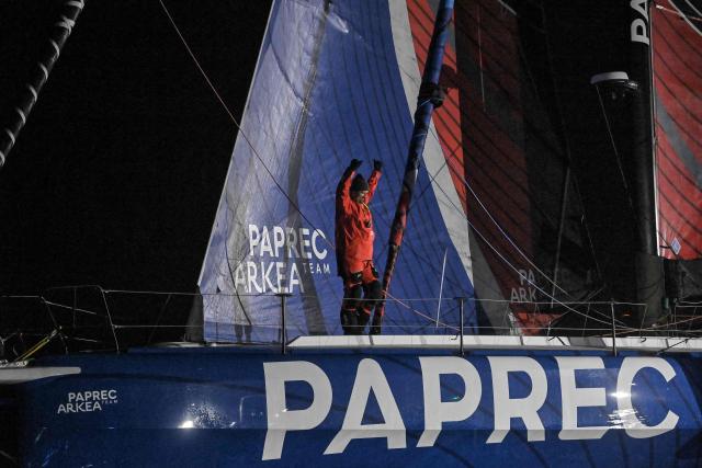 French skipper Yoann Richomme sails his Imoca 60 monohull Paprec Arkea, celebrates after crossing the line to finish in second place in the 10th edition of the Vendee Globe around the world monohull solo sailing race in Les Sables-d'Olonne, western France, on January 15, 2025. (Photo by Sebastien Salom-Gomis / AFP)