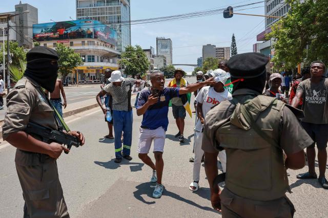 A protester argues with Mozambique police officers in Maputo on January 15, 2025, following the inauguration of Daniel Chapo as the President of Mozambique. Mozambique swore in Daniel Chapo as president on January 15, 2025 following months of post-election violence that an NGO says has killed more than 300 people.
Vowing "to devote all my energies to defending, promoting and consolidating national unity", Chapo, 48, extends his Frelimo party's 50-year rule of the gas-rich African nation. Opposition candidate Venancio Mondlane claims that the October 2024 election was rigged. (Photo by PHILL MAGAKOE / AFP)