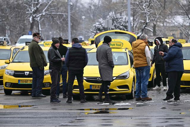 Taxi drivers line up their vehicles at an important traffic point of the Hungarian capital, the  Heroes' Square in Budapest during their demonstration against the Orban's government financial, tax policy on January 15, 2025. (Photo by Attila KISBENEDEK / AFP)