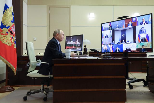 In this pool photograph distributed by the Russian state agency Sputnik, Russia's President Vladimir Putin chairs a video conference meeting of the Pobeda (Victory) organising committee to discuss preparations for the 80th anniversary of the victory over Nazi Germany in World War Two, at the Novo-Ogaryovo residence, outside Moscow, on January 15, 2025. (Photo by Alexander KAZAKOV / POOL / AFP)