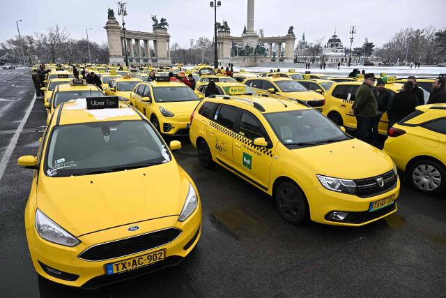 Taxi drivers line up their vehicles at an important traffic point of the Hungarian capital, the  Heroes' Square in Budapest during their demonstration against the Orban's government financial, tax policy on January 15, 2025. (Photo by Attila KISBENEDEK / AFP)