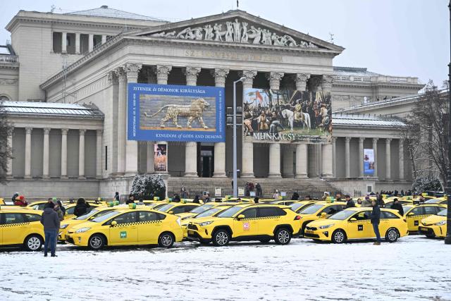 Taxi drivers line up their vehicles at an important traffic point of the Hungarian capital, the  Heroes' Square in Budapest during their demonstration against the Orban's government financial, tax policy on January 15, 2025. (Photo by Attila KISBENEDEK / AFP)