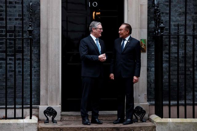 Britain's Prime Minister Keir Starmer (L) greets Malaysia's Prime Minister Anwar Ibrahim outside 10 Downing Street in central London on January 15, 2025 ahead of their meeting. (Photo by BENJAMIN CREMEL / AFP)