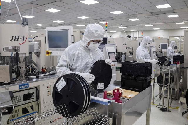 Employees inspectsemiconductor chips at a factory in Binzhou, in eastern China's Shandong province on January 15, 2025. (Photo by AFP) / China OUT