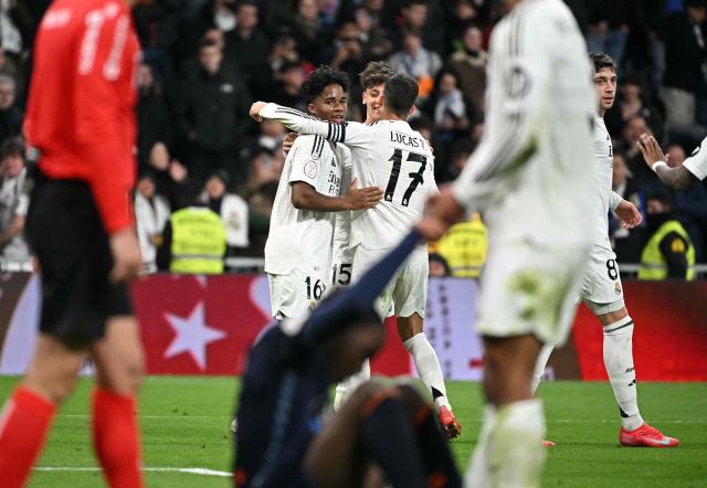 Real Madrid's Brazilian forward #16 Endrick (L) celebrates scoring his team's fifth goal with teammates during the Spanish Copa del Rey (King's Cup) last 16 first leg football match between Real Madrid CF and RC Celta de Vigo at the Santiago Bernabeu stadium in Madrid on January 16, 2025. (Photo by JAVIER SORIANO / AFP)