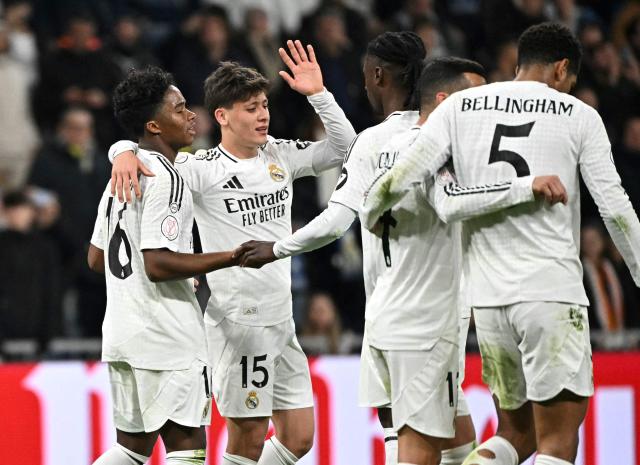 Real Madrid's Brazilian forward #16 Endrick (L) celebrates scoring his team's fifth goal with teammates during the Spanish Copa del Rey (King's Cup) last 16 first leg football match between Real Madrid CF and RC Celta de Vigo at the Santiago Bernabeu stadium in Madrid on January 16, 2025. (Photo by JAVIER SORIANO / AFP)