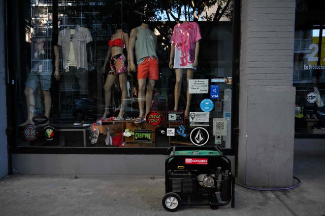 A power generator is pictured during a blackout in Buenos Aires on January 16, 2025. The National Weather Service issued an alert for "extreme temperatures" in central and northern Argentina, affecting 17 of the country's 23 provinces, including Buenos Aires, where due to the heat and high demand for electricity, nearly 40,000 homes suffered blackouts. (Photo by LUIS ROBAYO / AFP)