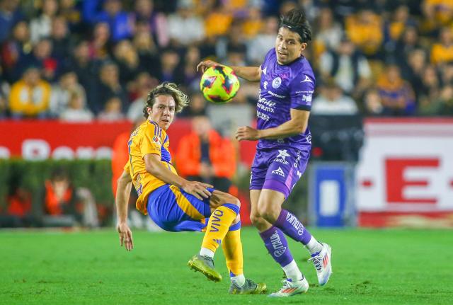 Tigres' midfielder #17 Sebastian Cordova (L) and Mazatlan's defender #15 Bryan Colula fight for the ball during the Liga MX Clausura football match between Tigres and Mazatlan at the Universitario (UANL) Stadium in San Nicolas de los Garza, Nuevo Leon State, Mexico on January 17, 2025. (Photo by Julio Cesar AGUILAR / AFP)