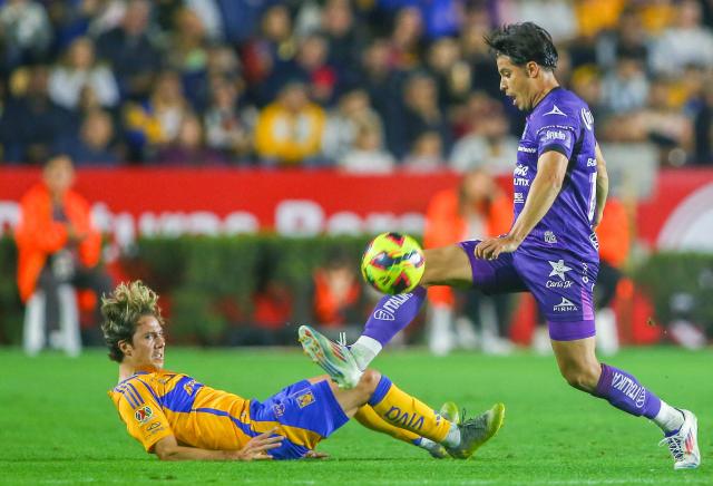 Tigres' midfielder #17 Sebastian Cordova (L) and Mazatlan's defender #15 Bryan Colula fight for the ball during the Liga MX Clausura football match between Tigres and Mazatlan at the Universitario (UANL) Stadium in San Nicolas de los Garza, Nuevo Leon State, Mexico on January 17, 2025. (Photo by Julio Cesar AGUILAR / AFP)