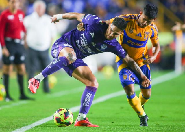 Mazatlan's Paraguayan forward #07 Luis Amarilla and Tigres' midfielder #14 Jesus Garza fight for the ball during the Liga MX Clausura football match between Tigres and Mazatlan at the Universitario (UANL) Stadium in San Nicolas de los Garza, Nuevo Leon State, Mexico on January 17, 2025. (Photo by Julio Cesar AGUILAR / AFP)