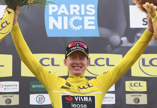 Team Visma-Lease a Bike's US rider Matteo Jorgenson wearing the overall leader's yellow jersey celebrates on the podium of the 5th stage of the Paris-Nice cycling race, 203,3 km between Saint-Just-en-Chevalet and La Côte-Saint-André, on March 13, 2025. (Photo by Anne-Christine POUJOULAT / AFP)