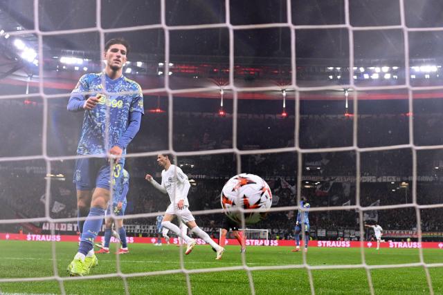 Ajax's Turkish defender #13 Ahmetcan Kaplan (L) reacts after the 2-0 goal scored by Frankfurt's German midfielder #27 Mario Goetze (not pictured) during the UEFA Europa League football match between Eintracht Frankfurt and AFC Ajax in Frankfurt am Main, western Germany on March 13, 2025. (Photo by Kirill KUDRYAVTSEV / AFP)